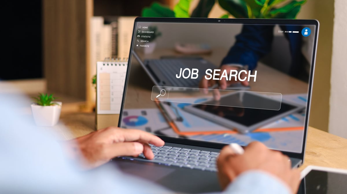 Person using laptop for online job search and filling out digital application