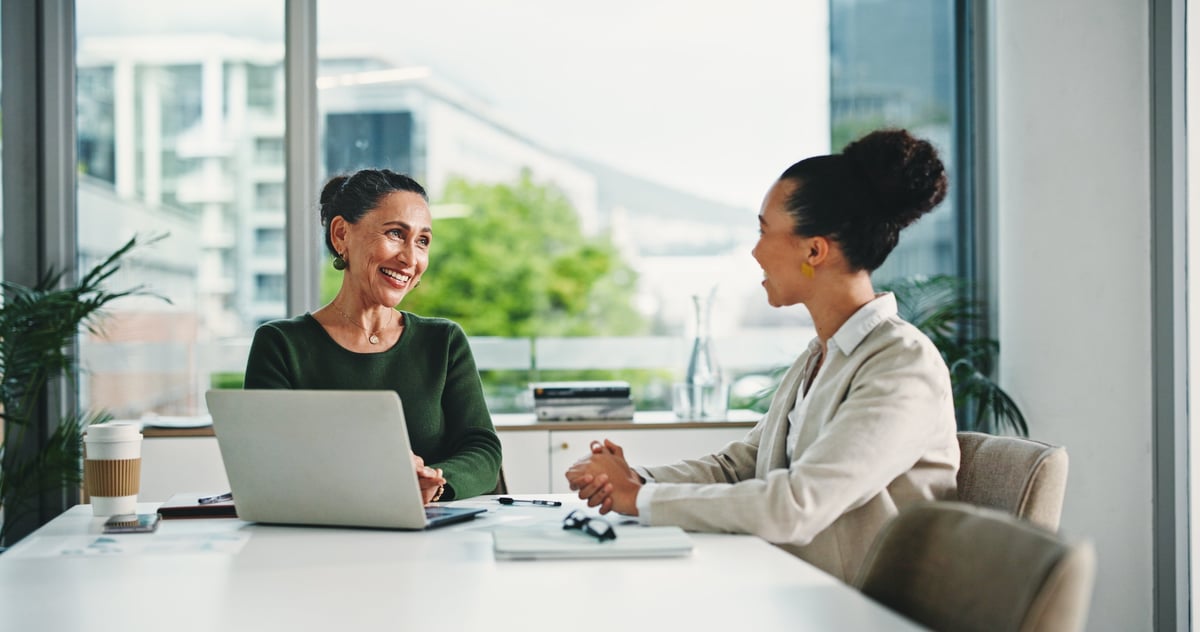 Career consultant meeting with a client in a modern Miami office, discussing career growth