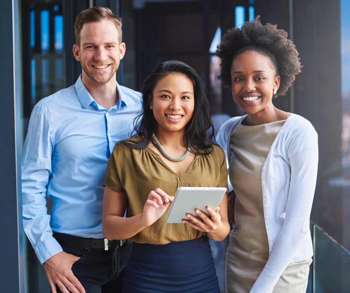 Diverse group of confident business professionals collaborating and smiling together